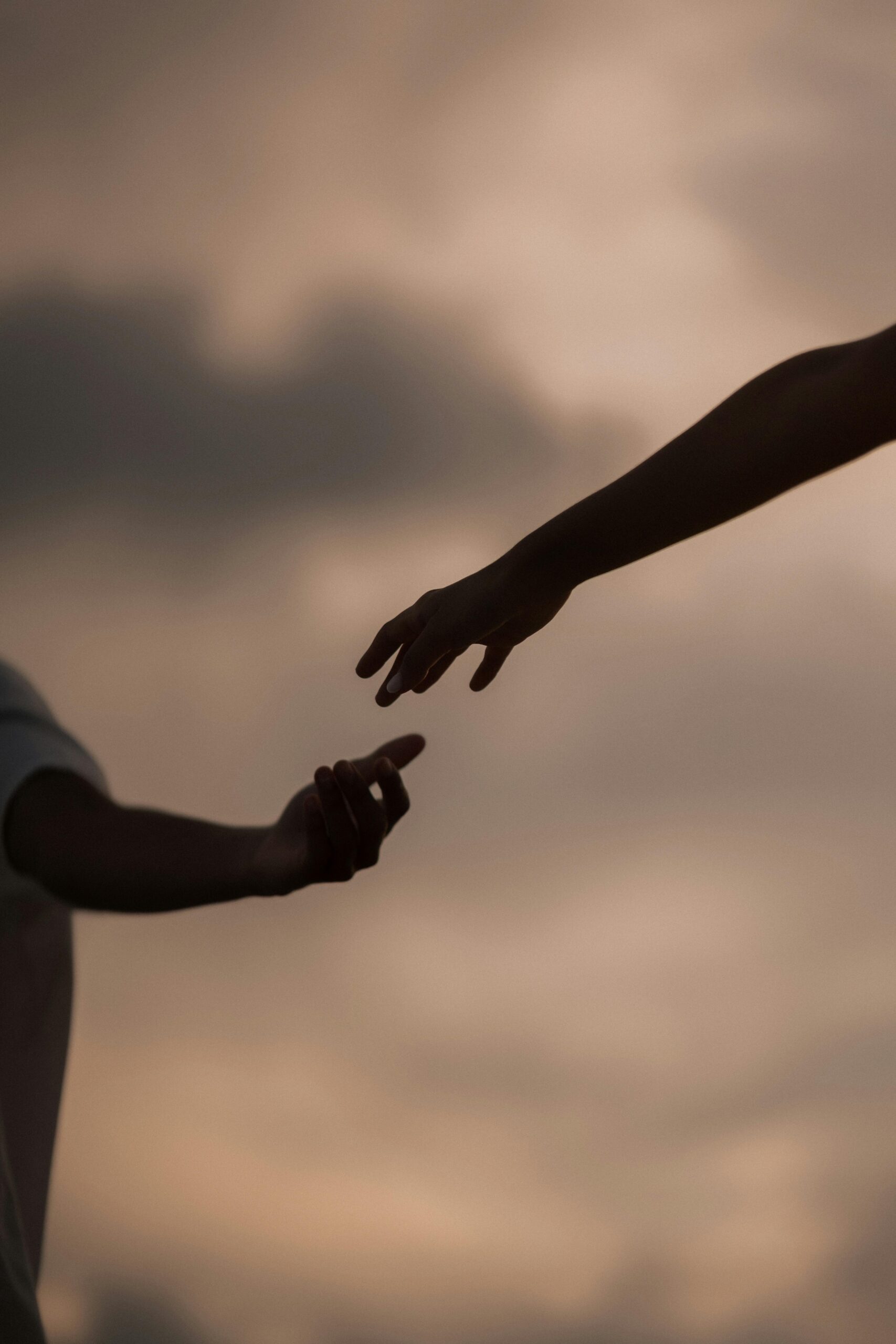 Two arms reaching out for each other for help.
